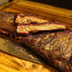 Sliced rack of Dragon’s Breath #3 ribs with two spice-rubbed bones stacked on top, ready for delivery