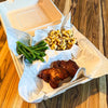 Kids BBQ meal featuring boneless chicken thigh, Velvety Mac & Cheese, and green beans in a three-compartment tray