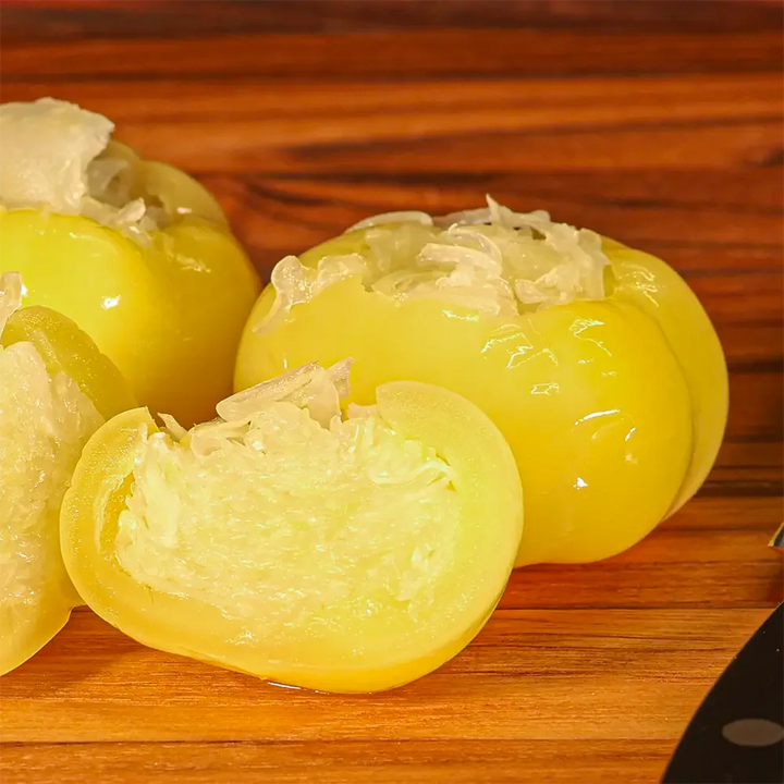 Close-up of a cabbage-stuffed yellow pepper showing its pickled texture and vibrant color, a Hungarian specialty offered by Pendragon’s