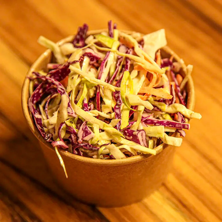 Close-up of Pendragon’s 8oz coleslaw container filled with crisp cabbage and carrots in a creamy dressing