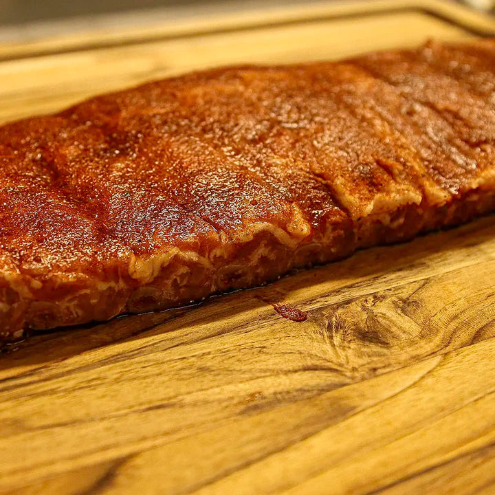 Two-thirds of a rack of Dragon’s Breath #3 ribs, sliced and seared, with the edge fading out of frame