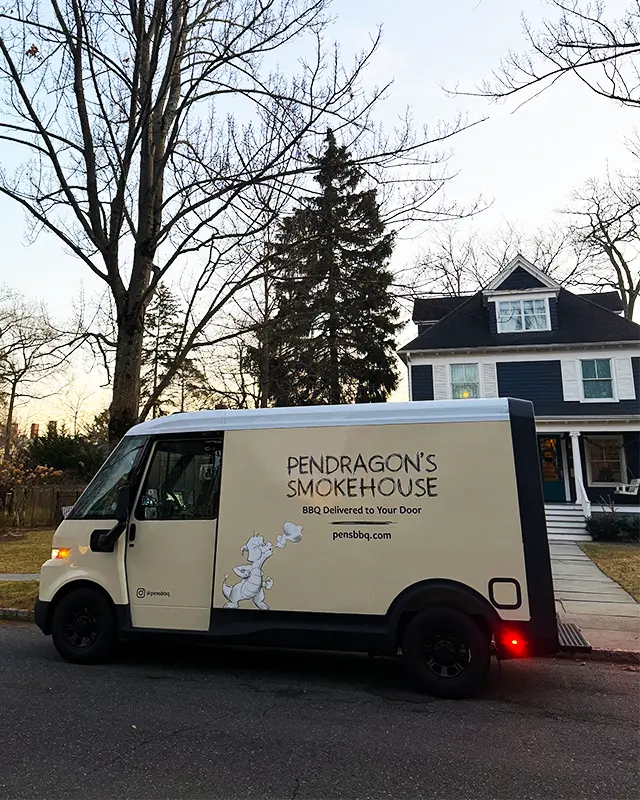 Van with 'Pendragon's Smokehouse' branding parked on a residential street in Nutley NJ.