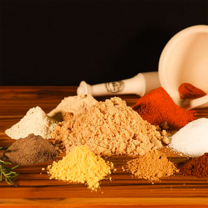 Rustic spice mix for Pen’s House ribs laid out in mounds, highlighting classic BBQ flavors with a Pendragon’s twist